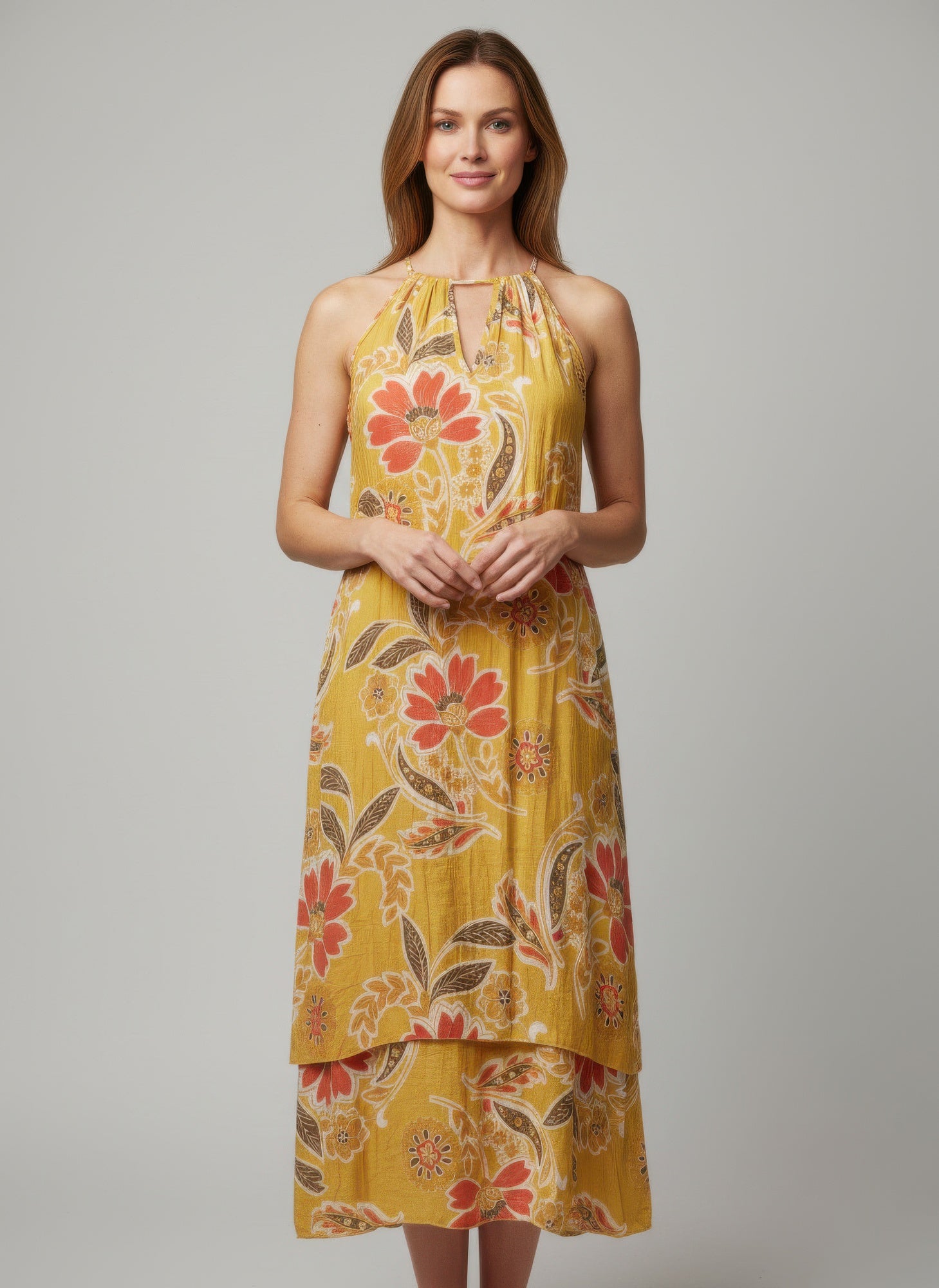 Simmer & Fay – model wearing Mlle Gabrielle floral sleeveless high-low dress with ruffle accents and necklace neckline detail