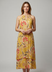 Simmer & Fay – model wearing Mlle Gabrielle floral sleeveless high-low dress with ruffle accents and necklace neckline detail