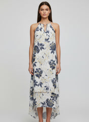 Simmer & Fay – model wearing Mlle Gabrielle floral sleeveless high-low ruffle dress with necklace neckline detail