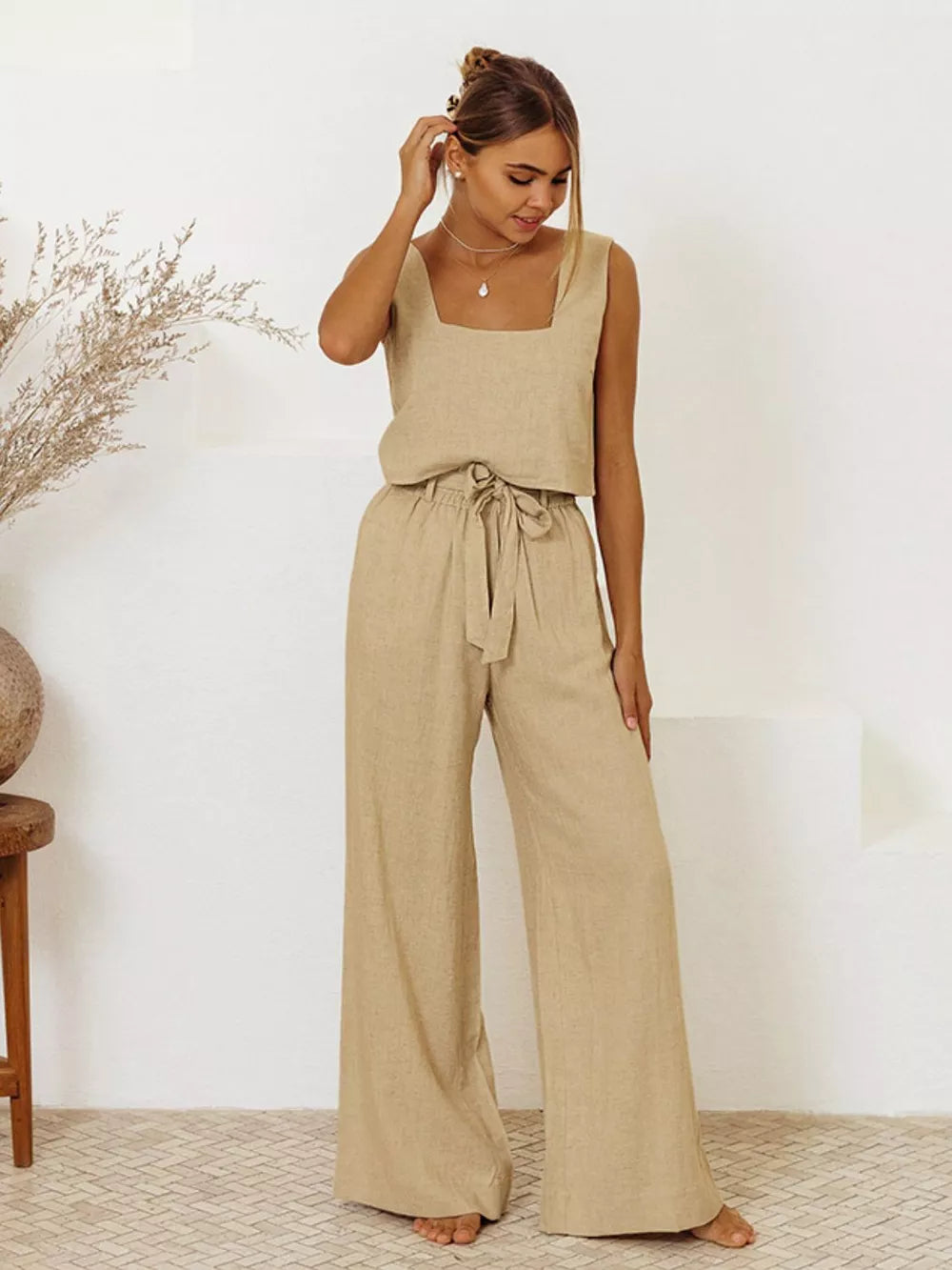 Woman wearing a tan square neck sleeveless cotton top with matching wide-leg tie-waist pants set