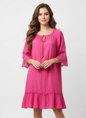 Simmer & Fay — model wearing Mlle Gabrielle Cabaret pink solid elbow sleeve dress with crochet cuff detail and tie neckline