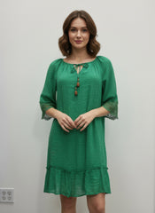 Simmer & Fay – model wearing Mlle Gabrielle solid green elbow sleeve dress with crochet sleeve trim and notch elastic neckline